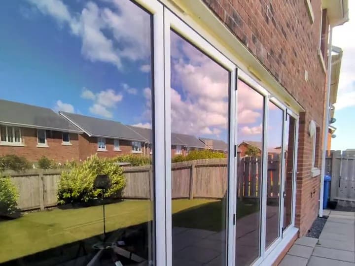 Patio doors with solar film: a reflective finish from the garden, then a bright clear view from the dining room